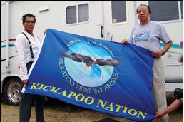 OFFICIAL FLAG. Steve Cadue, right, chairman of the Kickapoo Tribe in Kansas, presents the tribe's official flag to Hollywood actor Wes Studi,left, at 'The Only Good Indian' movie location in Cottonwood Falls, KS.(PRNewsFoto/Kickapoo Tribe)